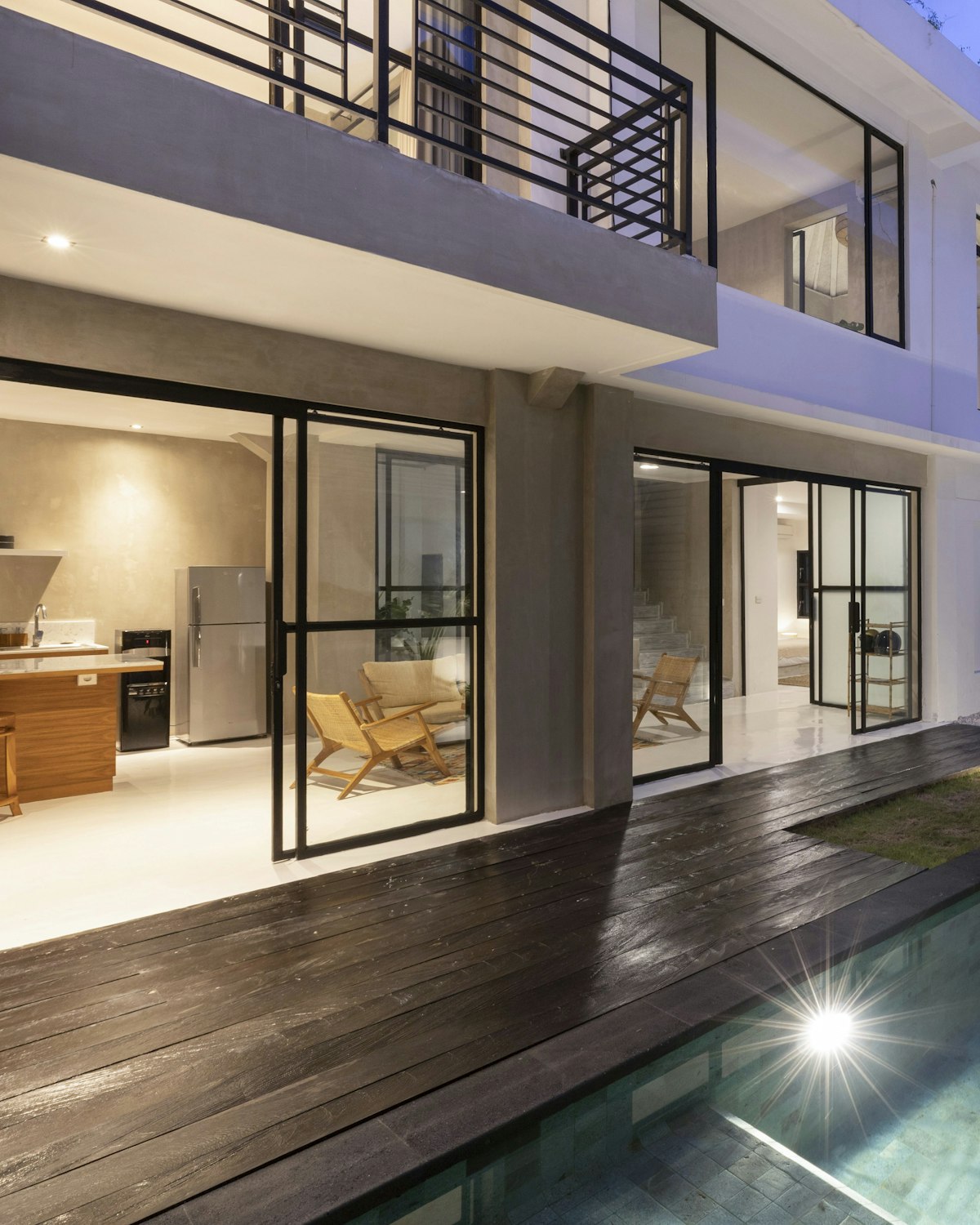 Timber deck and pool terrace lit for evening use.